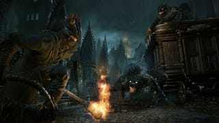 The player hunter in Bloodborne crouched with a torch, a werewolf-like creature stalking them nearby in Bloodborne.