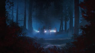 Kat, Autumn, Nora, and Swann walk through eerily blue-lit woodlands at night, illuminated by flashlights.