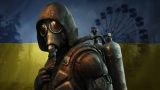 A gas-mask-wearing character from Stalker 2 stands and looks to the camera, with a Ukrainian flag faded in behind him and the Chernobyl ferris wheel slightly visible behind.